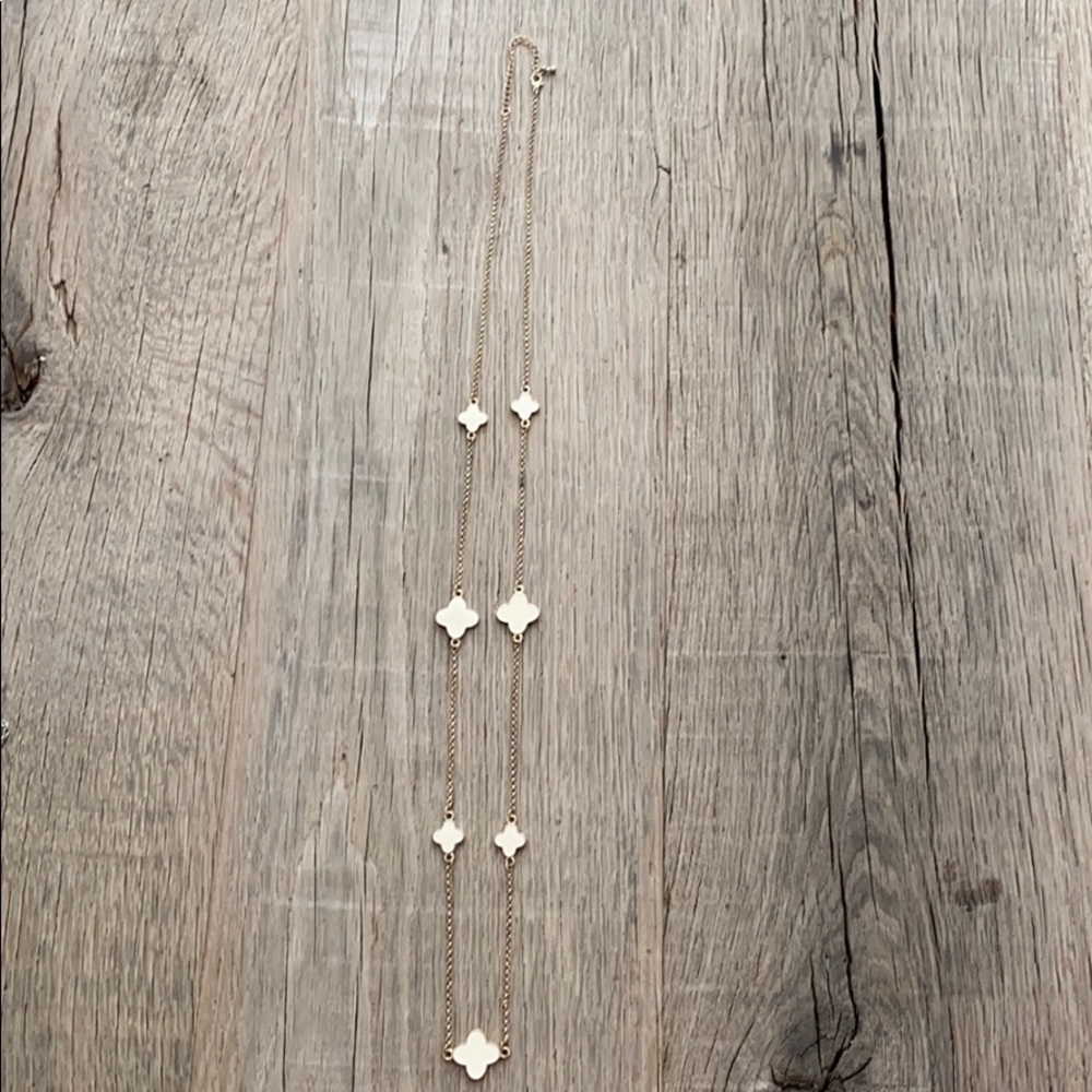 Gold long necklace with cream colored clovers